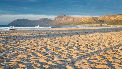 Sandy beach beach Playa Sa Canova in Son Serra de Marina, behind Serres de Llevant mountains