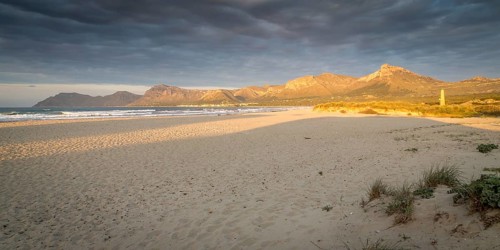 Evening atmosphere at the sandy beach Playa Sa Canova in Son Serra de Marina, in the back mountains Serres de Llevant