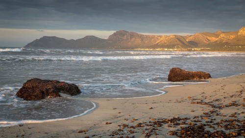 Evening atmosphere at the sandy beach Playa Sa Canova in Son Serra de Marina, in the back mountains Serres de Llevant