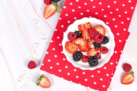 Top view of berry mix yogurt bowl with strawberry, raspberry and blackberry fruits and puffed quinoa