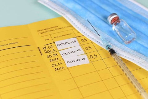 Corina virus booster vaccination concept showing vaccine passport with 3 entries,