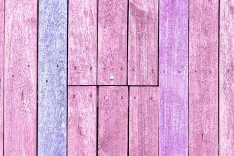 Wooden background with pink and purple painted planks,