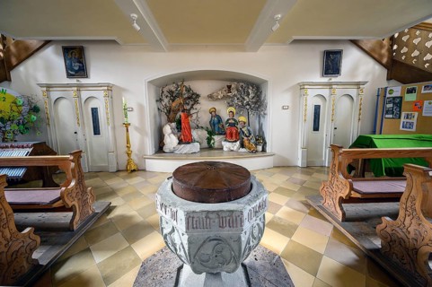 Baptismal font and figures of saints, praying disciples on the Mount of Olives
