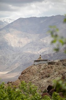 Maitreya Buddha at Hemis Gompa, Shang mountain range in the background