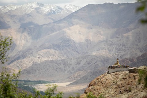 Maitreya Buddha at Hemis Gompa, Shang mountain range in the background