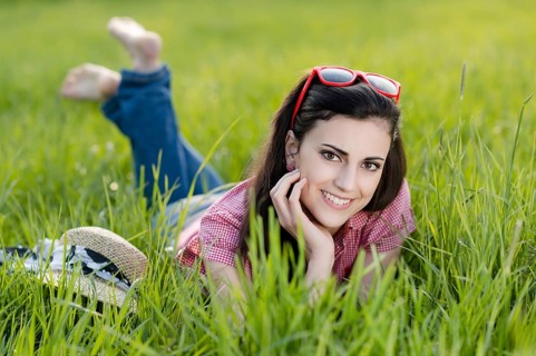 Young woman lying in meadow,