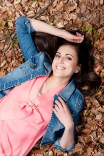 Young woman lying on the forest floor,