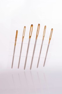 Six different sewing needles isolated on a white background,