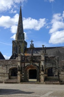 Enclosed parish Enclos paroissial Eglise Saint-Salomon de La Martyre with Gothic Flamboyant-style triumphal arch, Finistere department