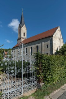Wrought-iron gate of the cemetery, in the back the neo-Gothic St. Catherine's Church