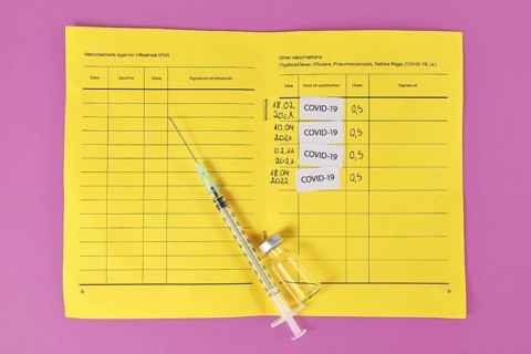 Concept for Corona virus booster vaccination showing vaccine passport with 4 entries,