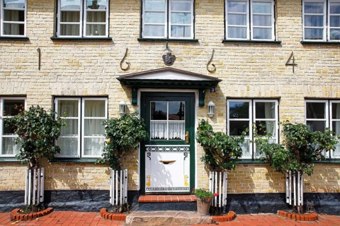 Old house from 1664 with decorative wooden door, Historic fishing settlement Holm