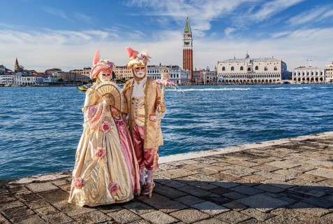 Carnival masks in front of the panorama of the city with Campanile and Doge's Palace, Venice