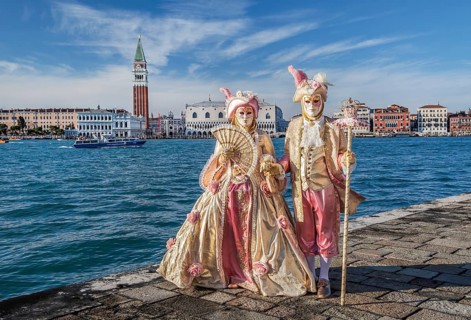 Carnival masks in front of the panorama of the city with Campanile and Doge's Palace, Venice