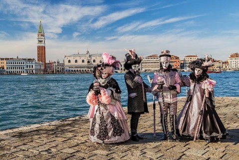 Carnival masks in front of the panorama of the city with Campanile and Doge's Palace, Venice