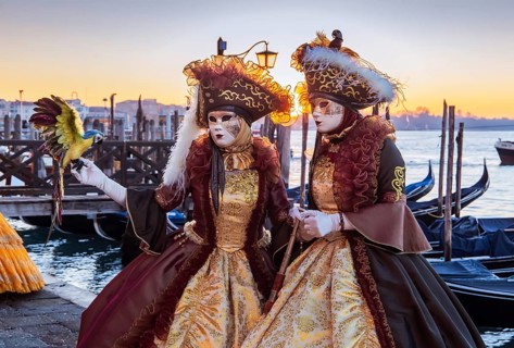 Carnival masks on the waterfront at sunrise, Venice