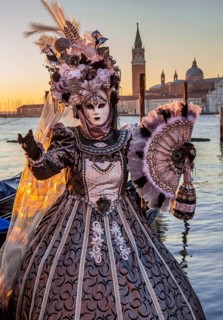 Carnival mask on the waterfront at sunrise, Venice