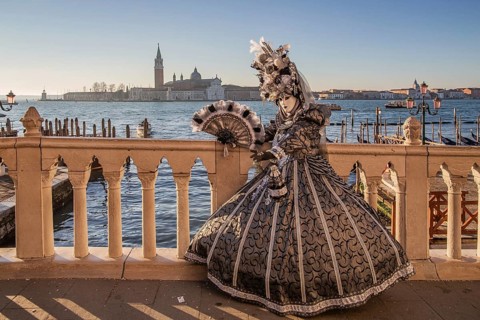 Carnival mask on the waterfront in front of San Giorgio Island, Venice