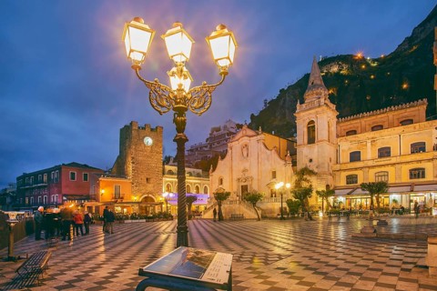 Belvedere Piazza IX Aprile with clock tower and church of San Giuseppe at dusk, Taormina