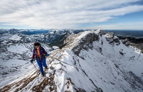 Climber on a rocky snowy ridge, hiking trail to Ammergauer Hochplatte