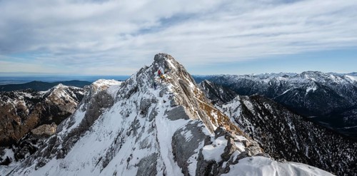Three mountaineers on a rocky snowy ridge, hiking trail to Ammergauer Hochplatte
