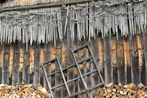 Shed wall with suspended hay riders,