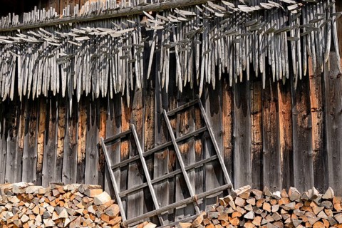 Shed wall with suspended hay riders,