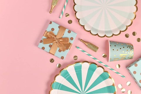 Party flat lay with teal blue paper plates, gift box