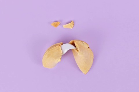 Cracked fortune cookie with note without text,