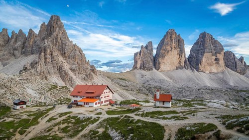 View of mountain hut Dreizinnenhuette and chapel with rock massif Paternkofel and mountain range drei Zinnen, panorama