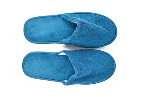 Soft blue home guest slippers on white background,