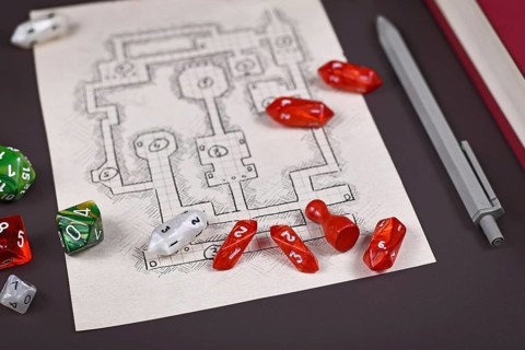 Roleplaying game dices on hand drawn dungeon adventure map. Concept for table top role playing games,