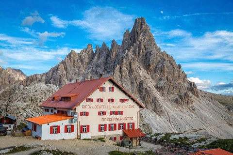 Mountain hut Dreizinnenhuette at dusk, in the background rock massif Paternkofel