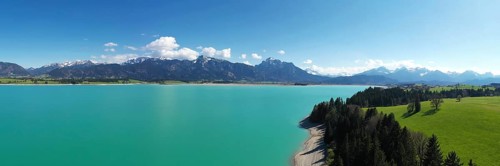 Lake Forggensee in the Koenigswinkel with the Alps in the background. Fuessen, Ostallgaeu