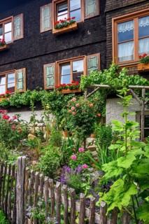 Wooden shingle facade with cottage garden, Hindelang