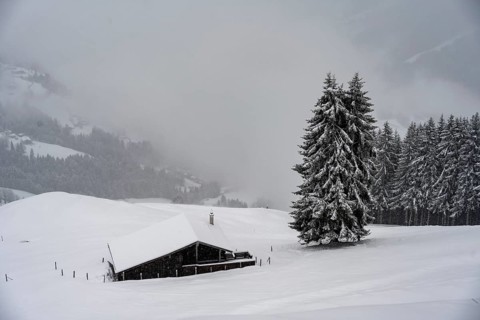 snowfall, mountain hut in the snow