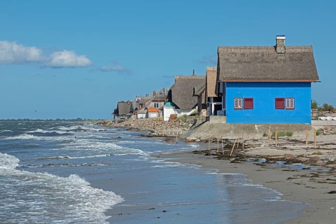 Thatched roof houses on the beach, Graswarder peninsula