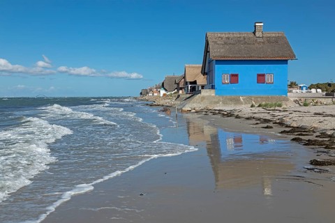 Thatched roof houses on the beach, Fehmarnsund Bridge