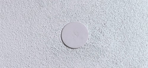 Power distribution box with cover cap in a wall,
