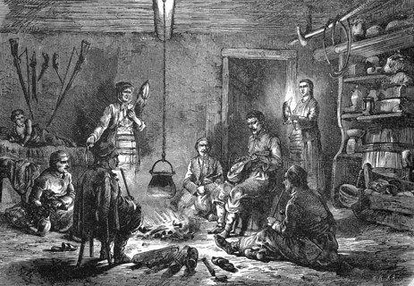 Scene in a farmhouse in Dalmatia, in the kitchen an open fire around which the men sit playing music and smoking