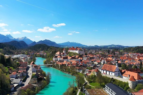 Aerial view of Fuessen with a view of the Lech river, the Benedictine monastery of St. Mang and the high castle. Ostallgaeu Swabia