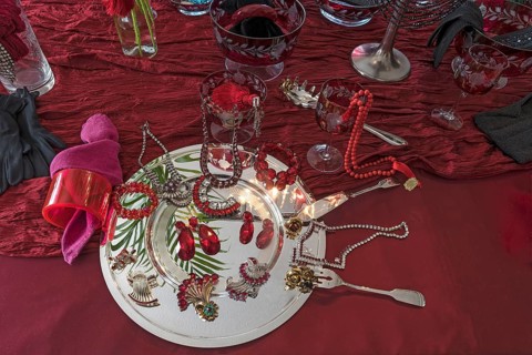 Rhinestone jewellery and accessories decorated on a silver plate and red cloth, Bavaria
