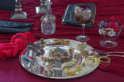 Rhinestone jewellery and accessories decorated on a silver plate and red cloth, Bavaria