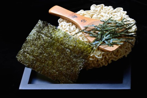 Nori, cut paper-like sheet of seaweed and Asian noodles with chopsticks