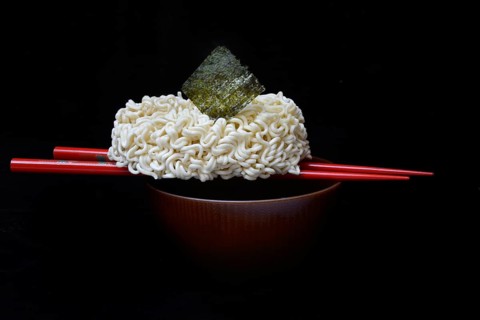 Nori, dried paper-like sheet of seaweed and Asian noodles on a shell