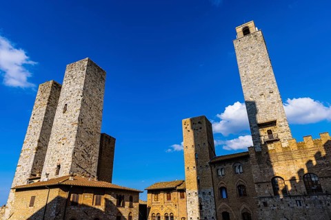 Gender towers and medieval buildings against a blue sky, San Gimignano