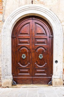Round arched house entrance door, edged with white marble