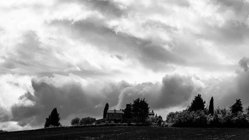 Dark clouds over a country house, black and white photograph