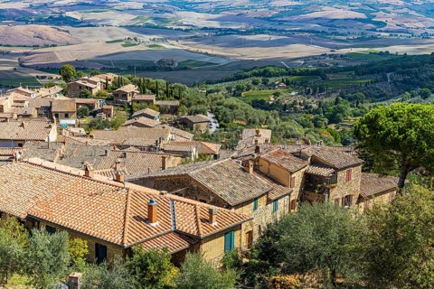 Above the rooftops of Montalcino, view of the Val dOrcia valley