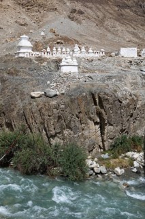 Small white stupa on the mountainside, Nubra River below